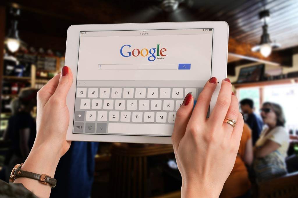 hands holding ipad in bar