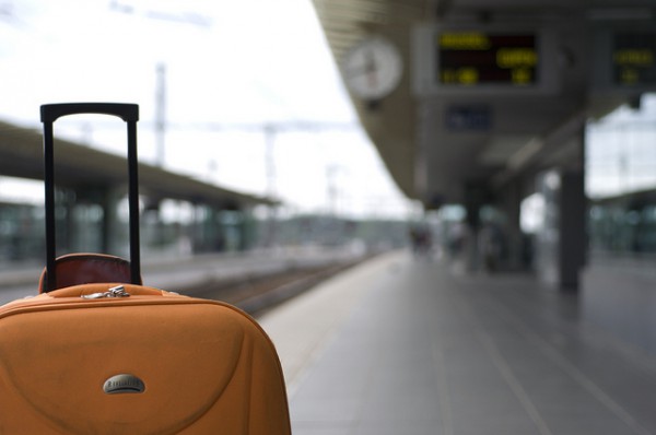 orange luggage on platform